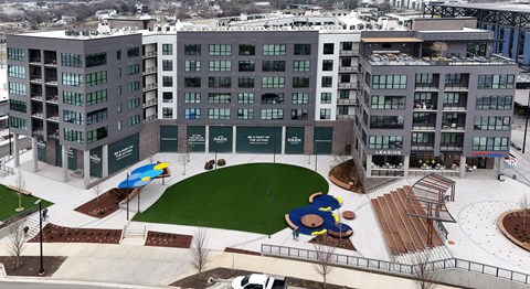A large building with a green lawn in front of it.