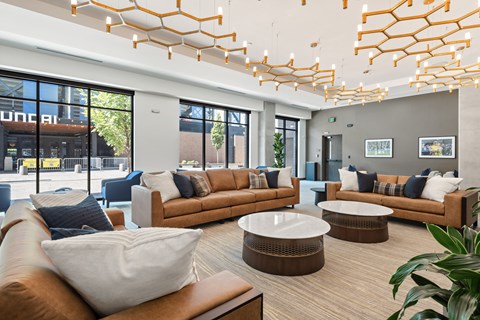 A modern living room with brown leather sofas and a wooden coffee table.