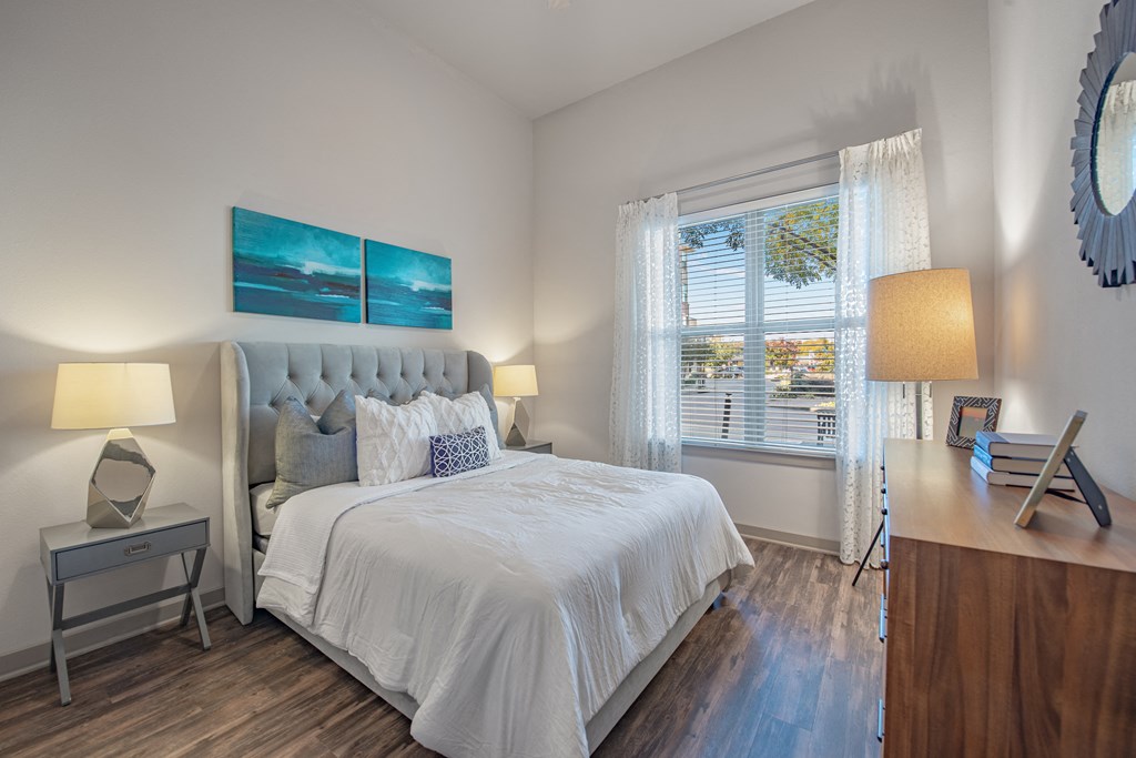 a bedroom with a large bed and a window