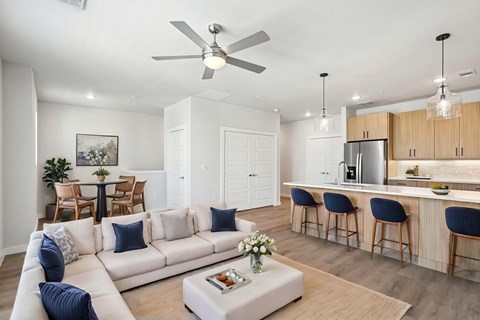 A living room with a white couch and a bar area.