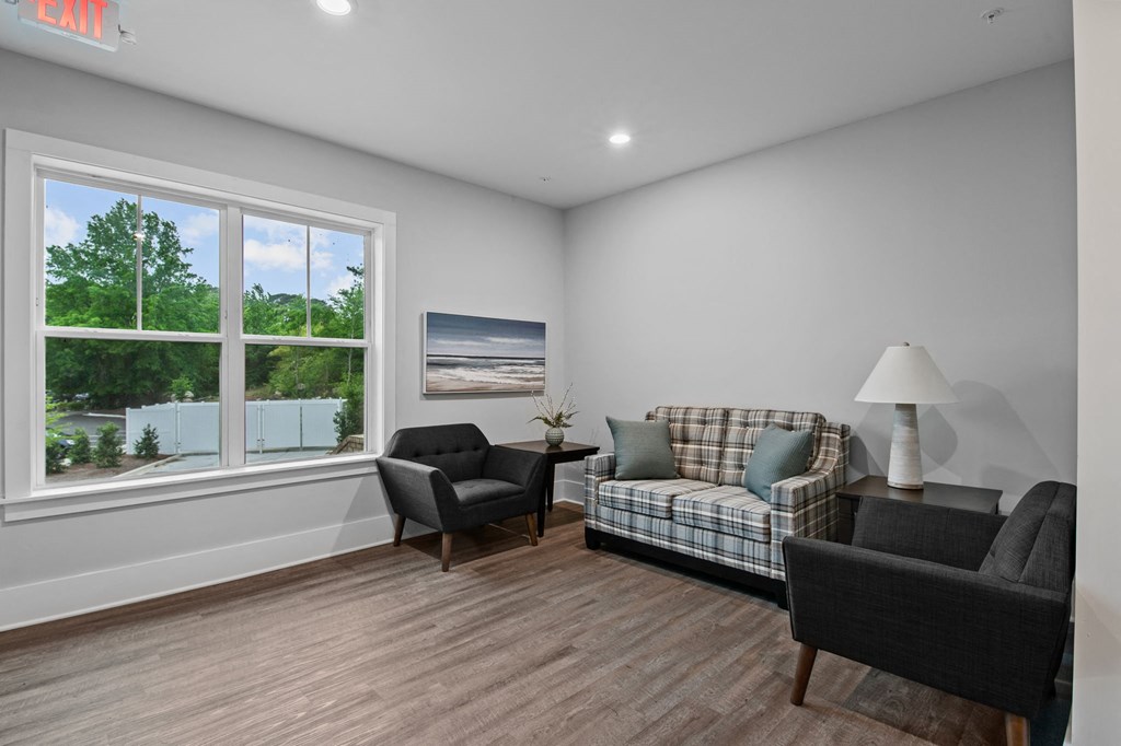a living room with couches and chairs and a large window