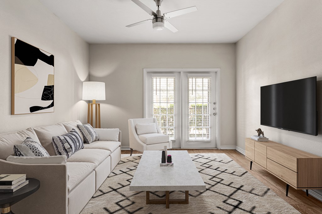 a living room with a white couch and a white coffee table