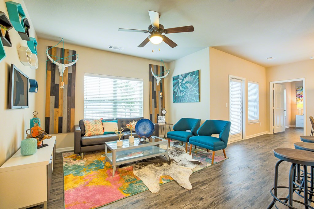 A living room with a grey couch and a blue chair.