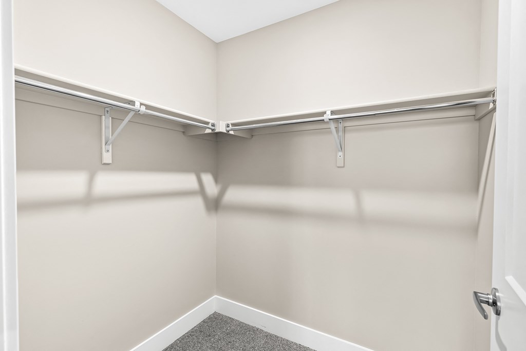 the preserve at ballantyne commons empty walk in closets with white walls and