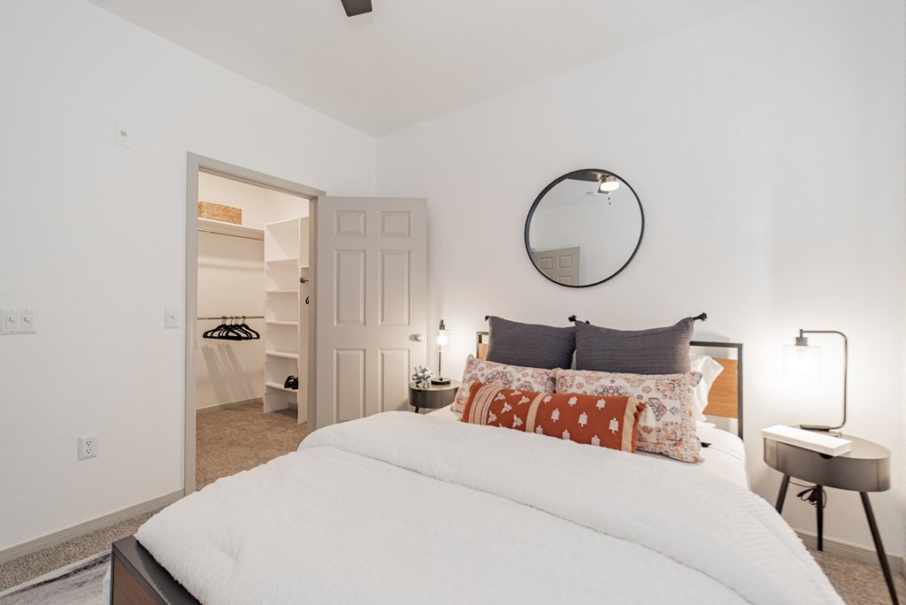 a bedroom with a bed and a closet and a mirror