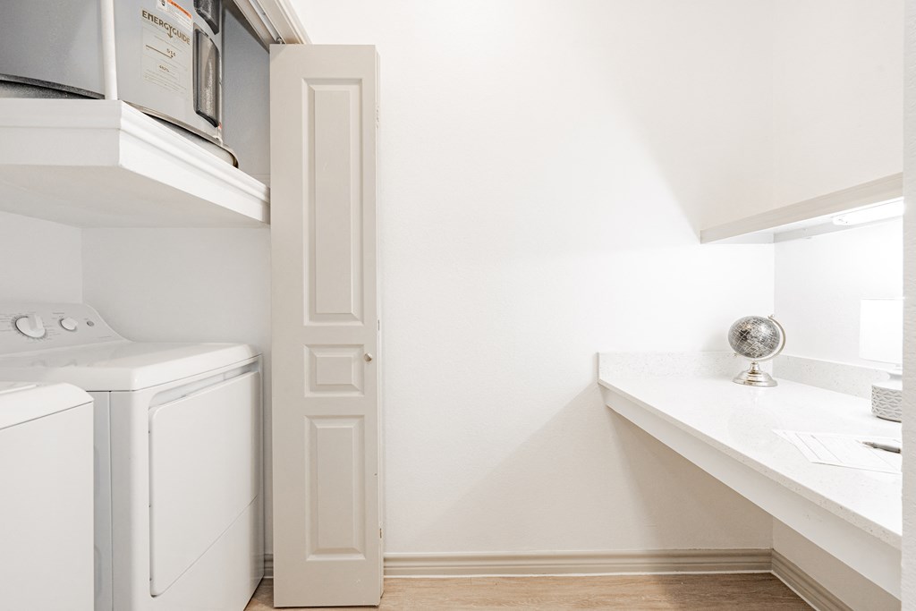 a laundry room with a washer and dryer and a window and a sink