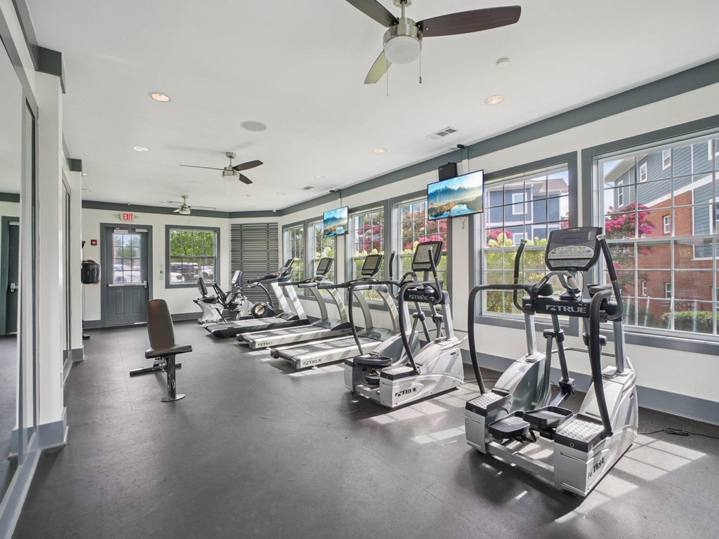 A gym with treadmills and exercise equipment.
