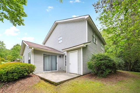 A house with a grey siding and a white garage door.