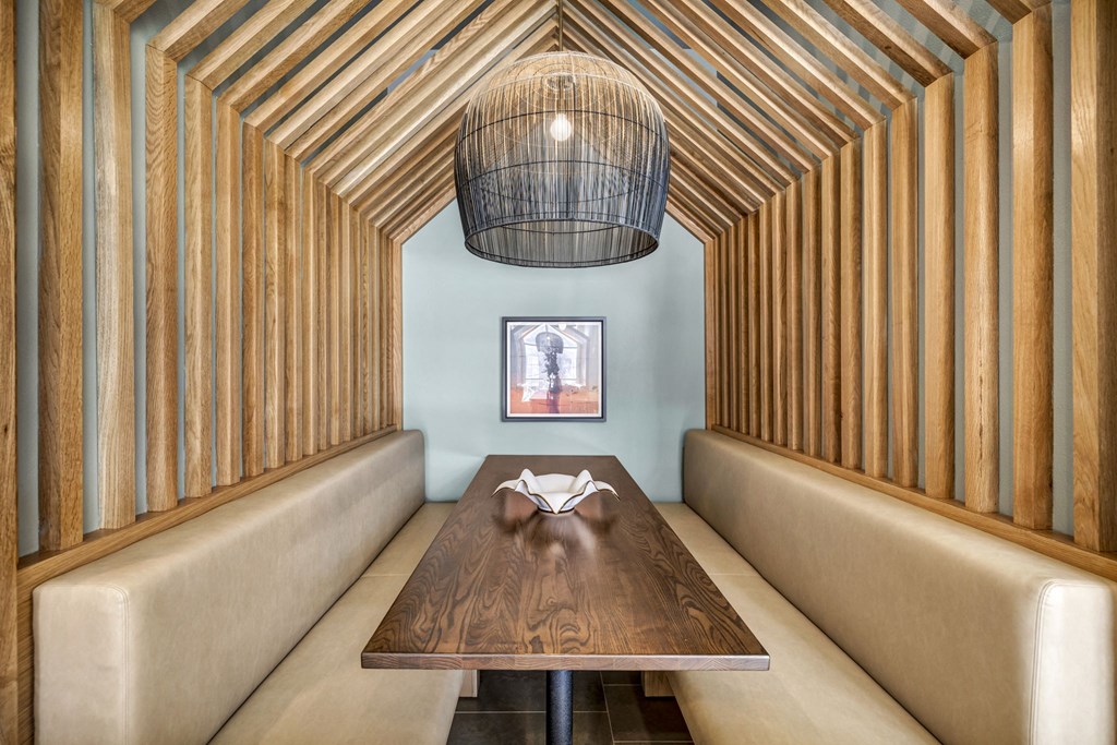 a dining room with a wooden table and a chandelier