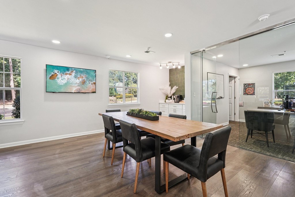 A dining room with a wooden table and chairs.