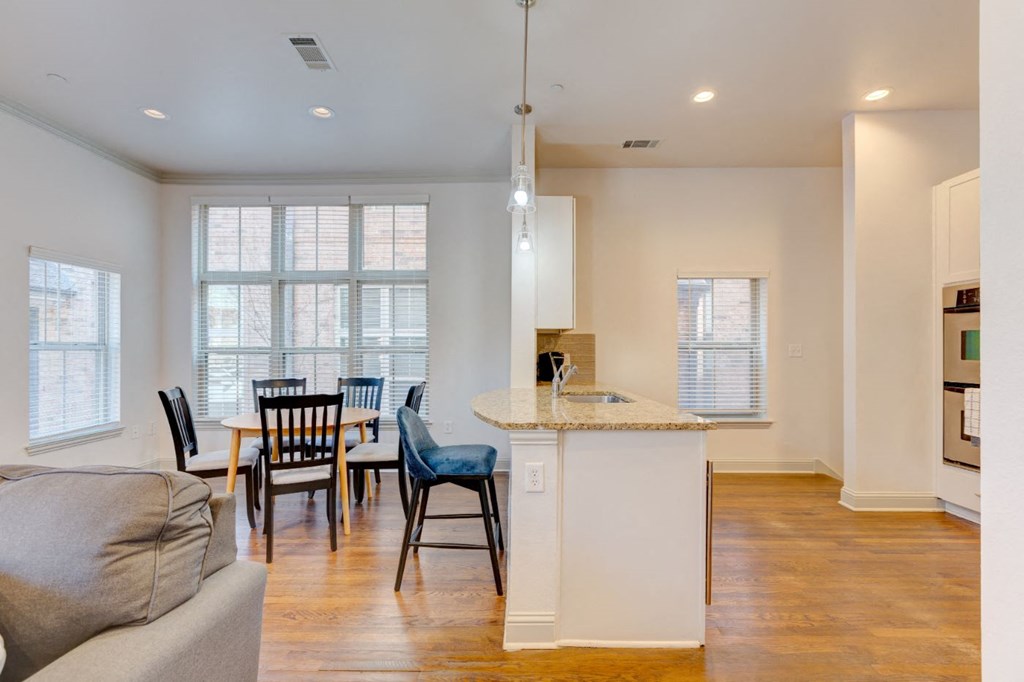 a living room with a kitchen and a dining table