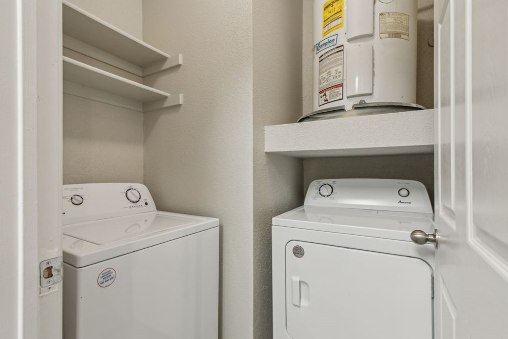 A white washing machine and dryer in a small laundry room.