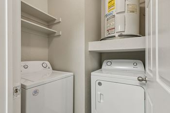 A white washing machine and dryer in a small laundry room.