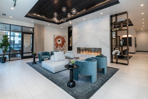 a living room with a couch and chairs and a fireplace