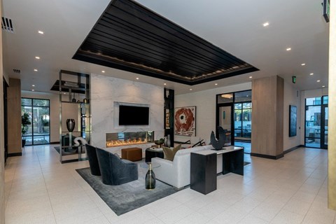 a large living room with a couch and a table