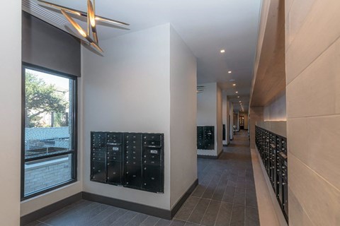 a long hallway with a wall of wine racks and a window