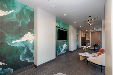 a living room with a large painting on the wall