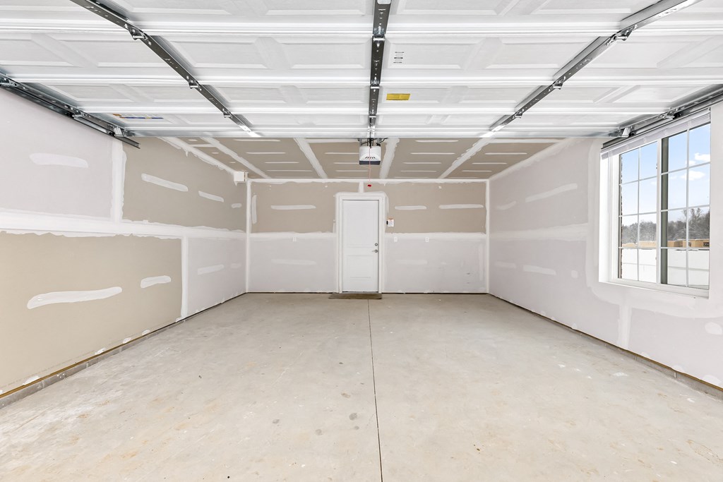 an empty room with white walls and a window