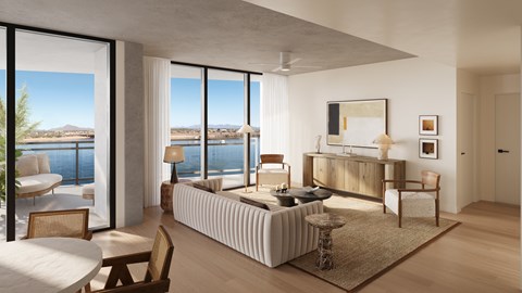 A modern bedroom with a large bed and a view of the water.