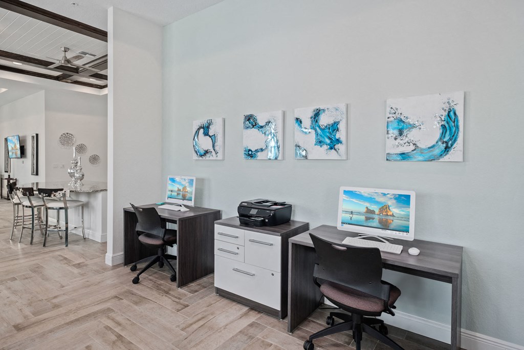 a office with desks and chairs and paintings on the wall