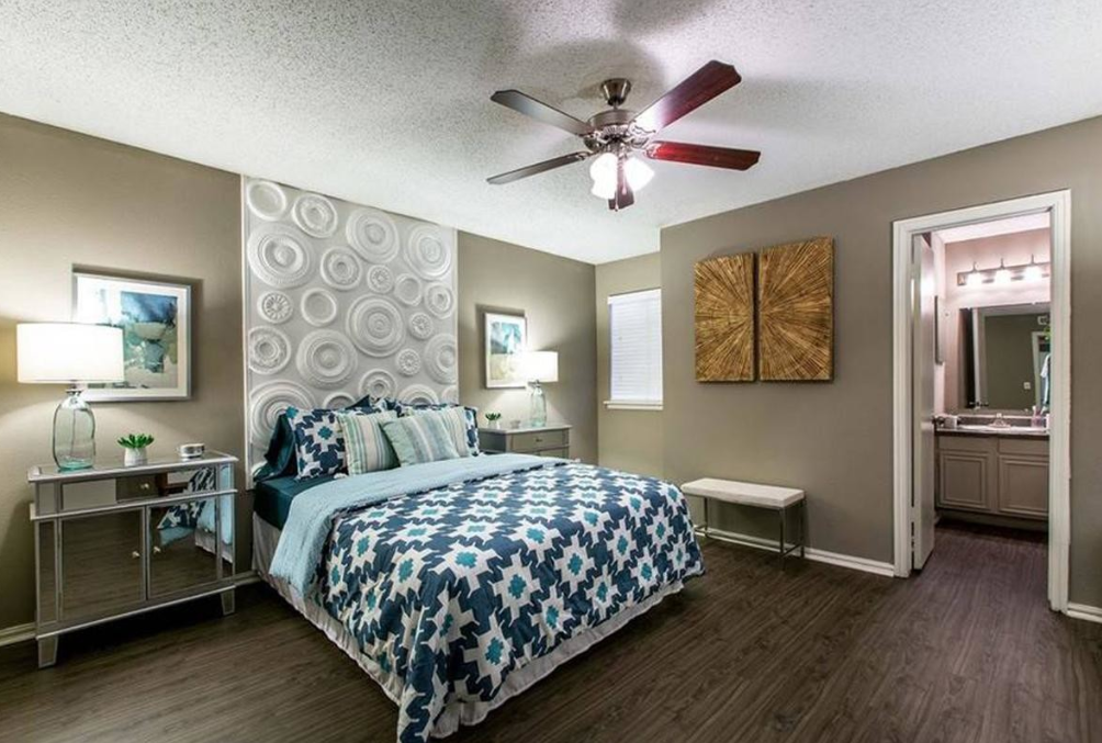 a bedroom with a bed and a ceiling fan