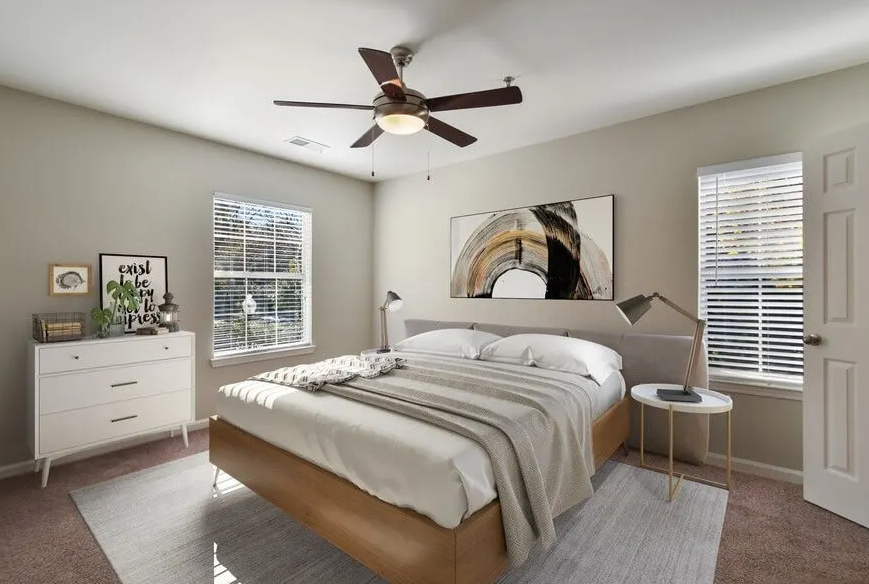 a bedroom with a bed and a ceiling fan