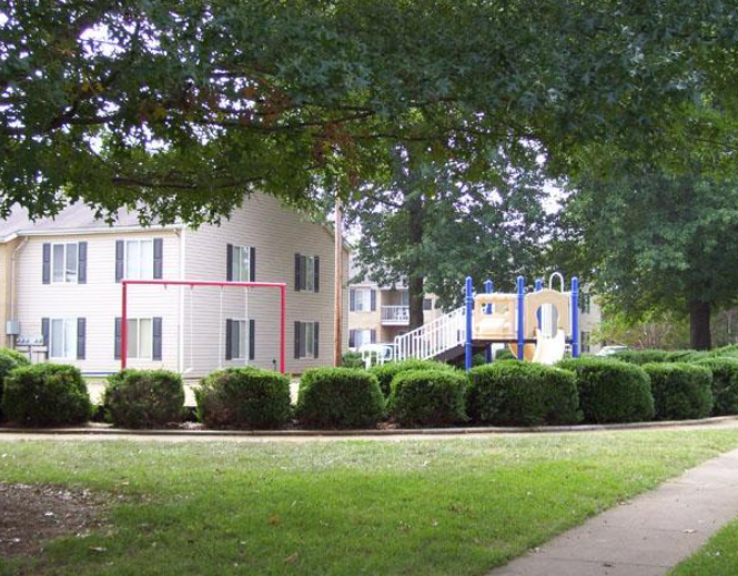 a playground in front of a white house