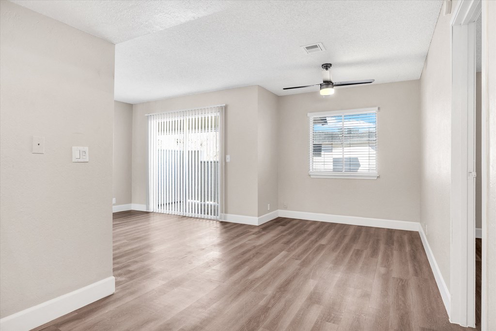 a bedroom with hardwood flooring and a window