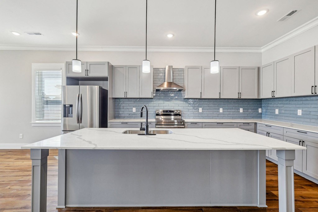 A modern kitchen with a large island in the center.