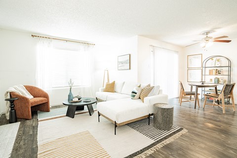 a living room with a white couch and a dining room table