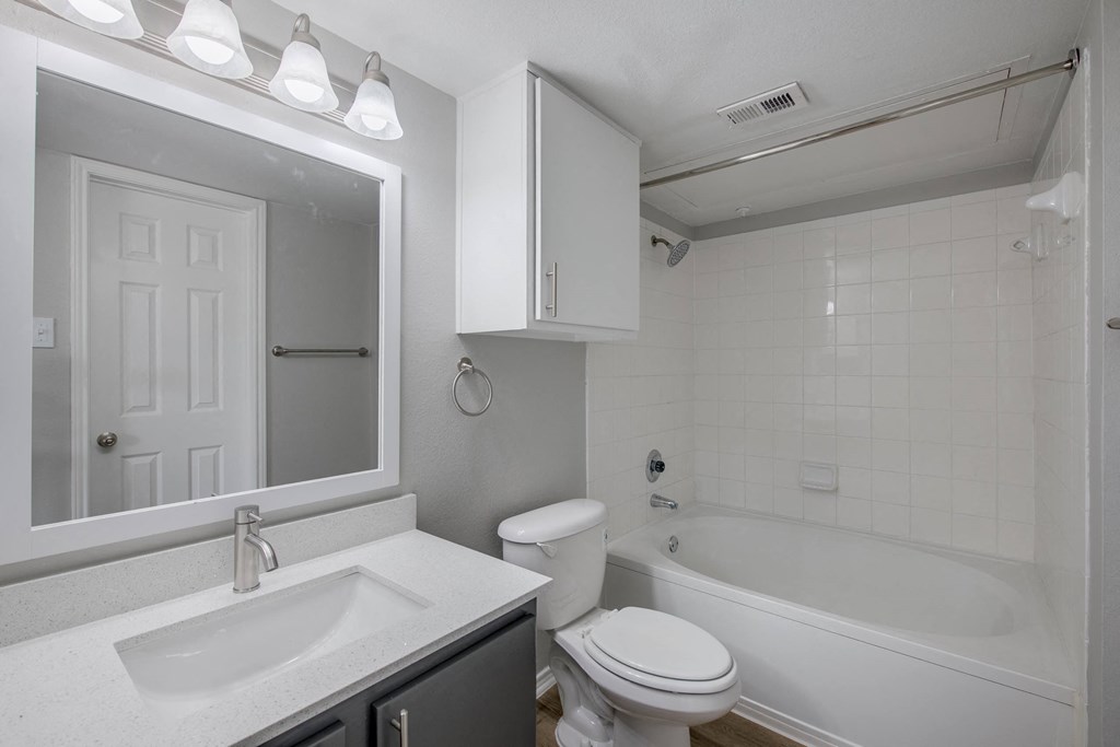a bathroom with a sink toilet and bathtub