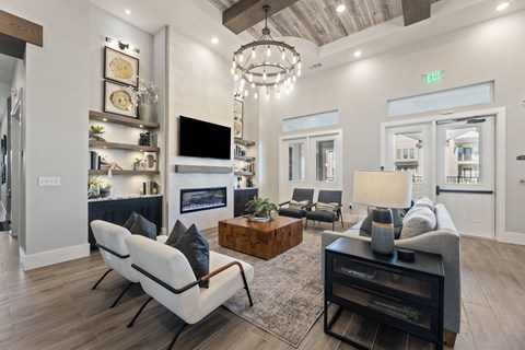 A modern living room with a white sofa and a wooden coffee table.