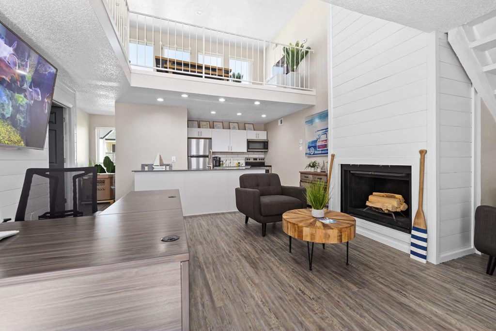 a living room with a fireplace and a table
