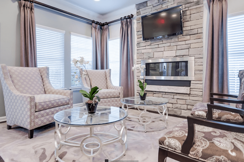 a living room with a fireplace and a table and chairs
