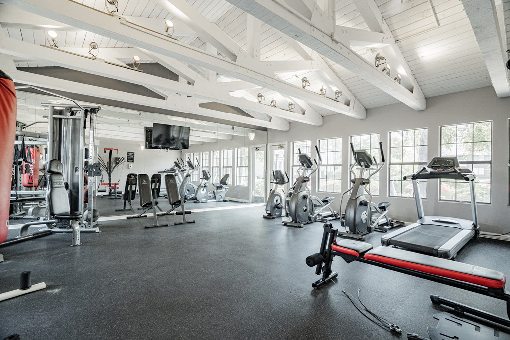 the gym with treadmills and other exercise equipment at the belgard apartments