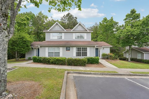 A house numbered 28 is surrounded by greenery.