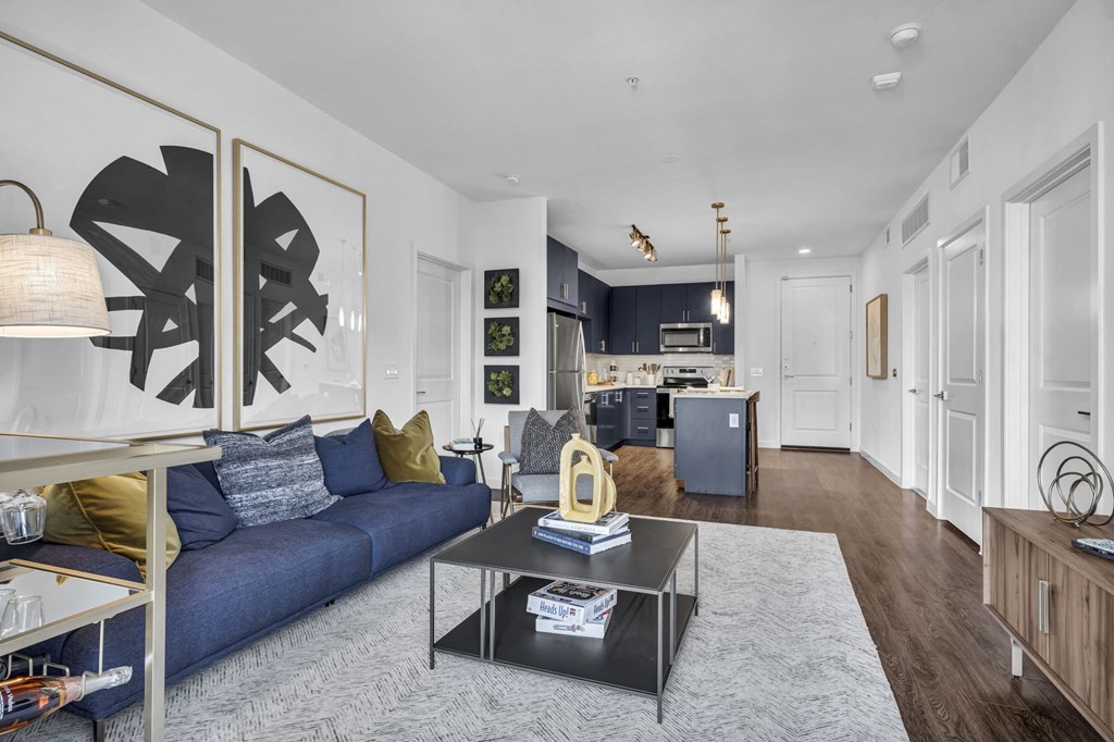 a living room with a blue couch and a coffee table