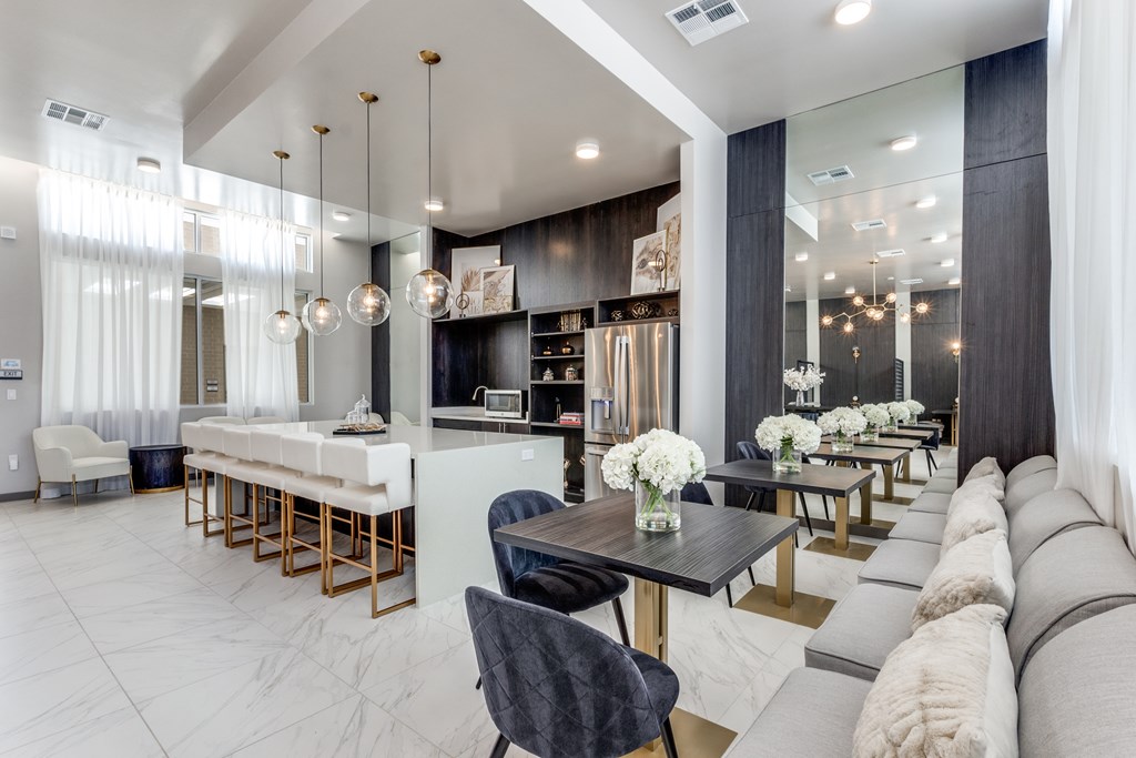 A modern living room with a long couch and a dining table.