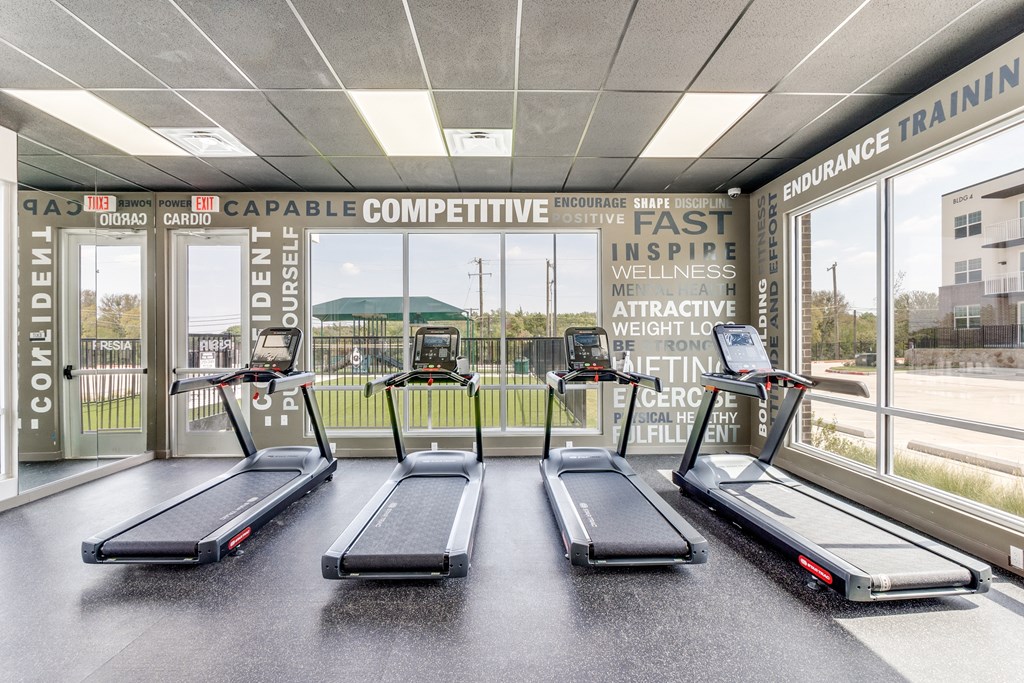 an image of a gym with treadmills