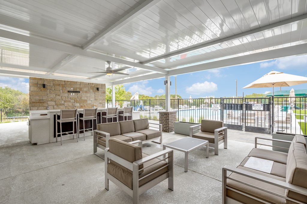 A patio with a white ceiling and furniture.