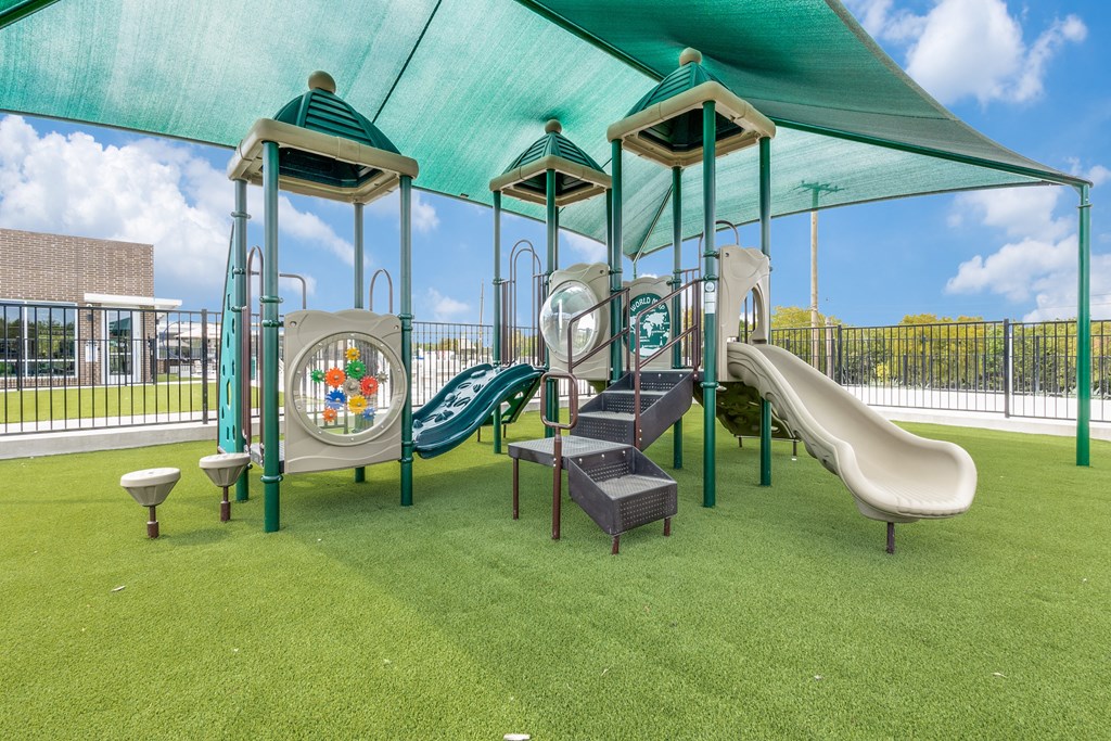 a playground with a swing set and slides