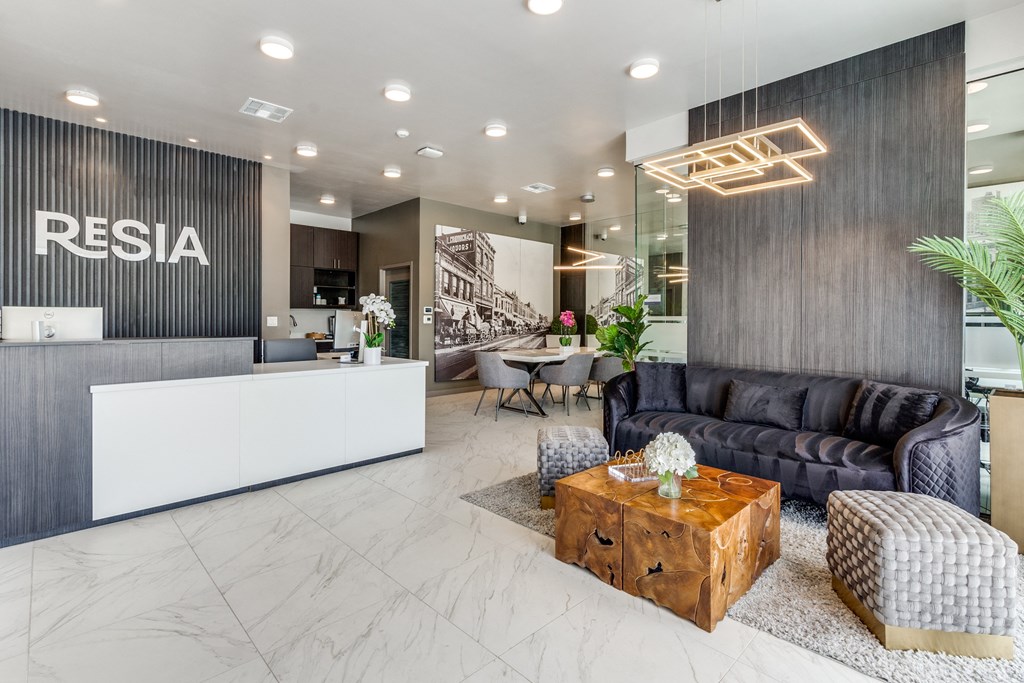 a lobby with a couch coffee table and a reception desk