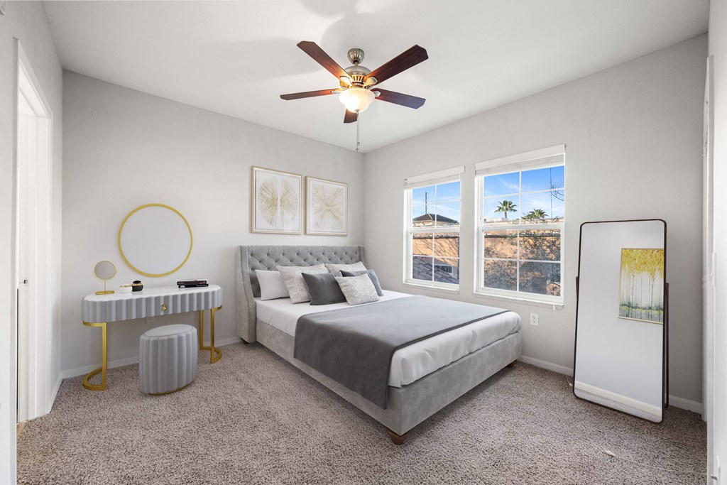 a bedroom with a bed and a ceiling fan
