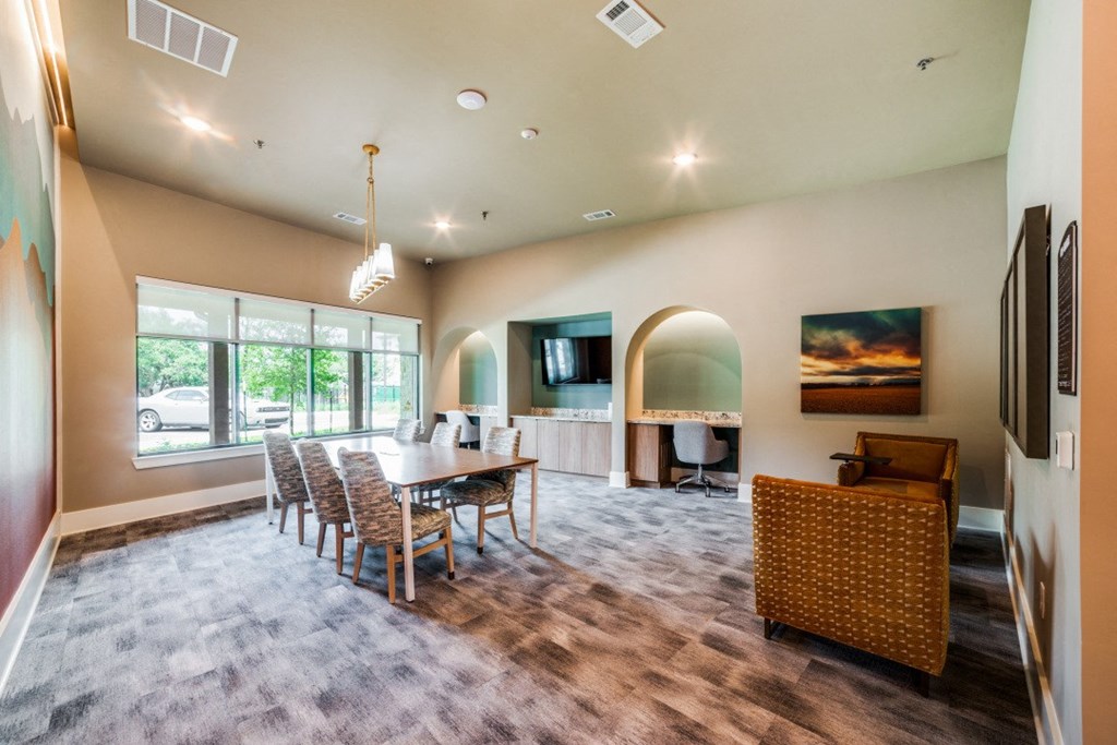 a living room with a dining room table and a fireplace