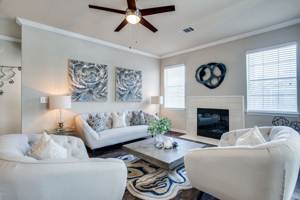 a living room with two white couches and a fireplace