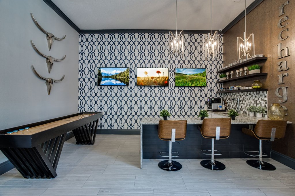 a restaurant with a table and chairs and a wall with artwork