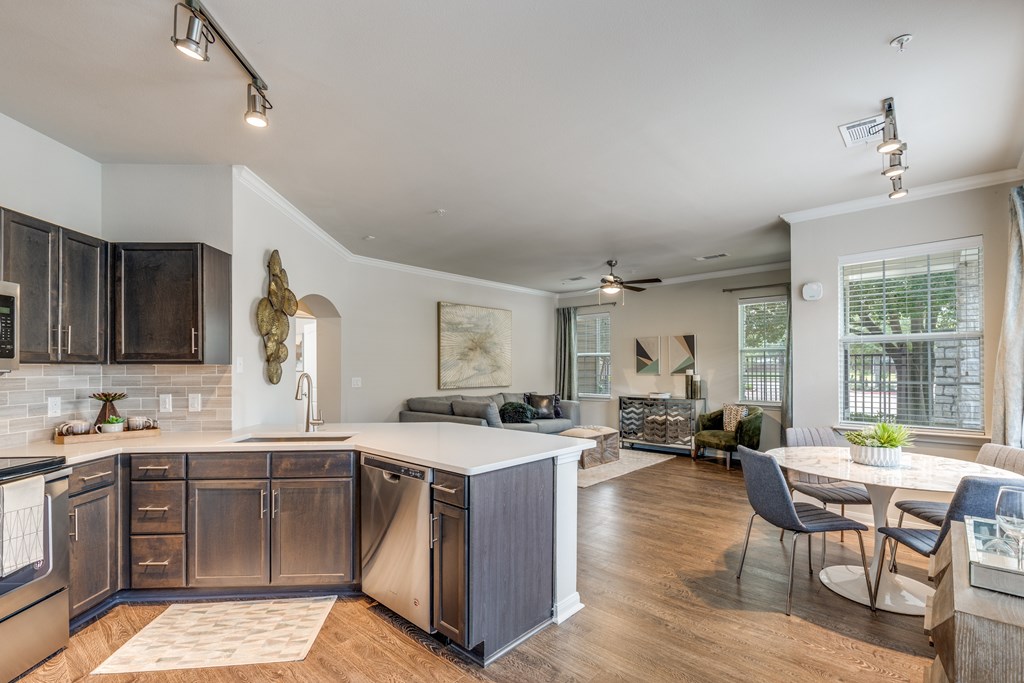 A modern kitchen with dark wood cabinets and a white island.