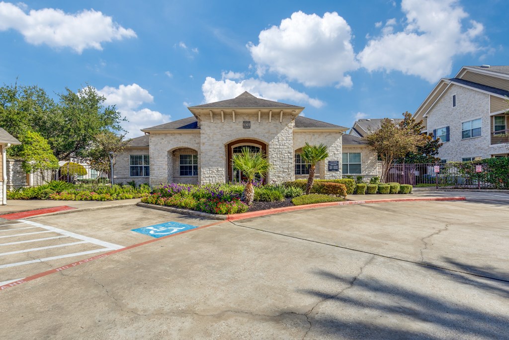 A parking lot with a handicap parking space in front of a building.