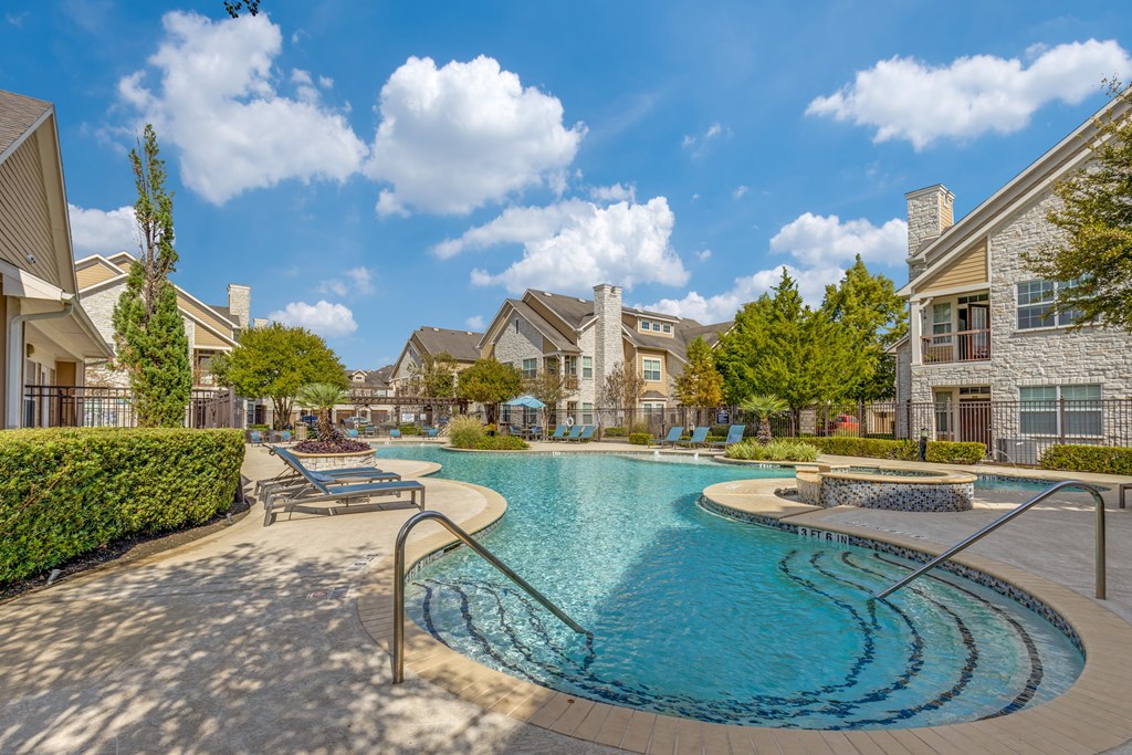 A swimming pool surrounded by a residential area.