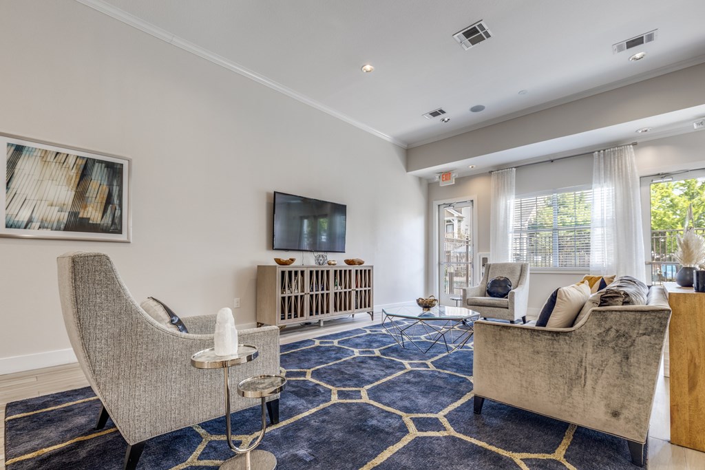 A living room with a grey chair and a brown sofa.